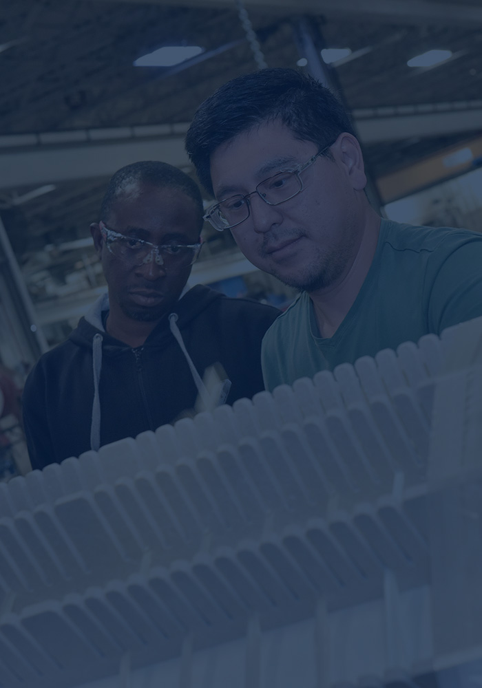 two technicians working on transformer core