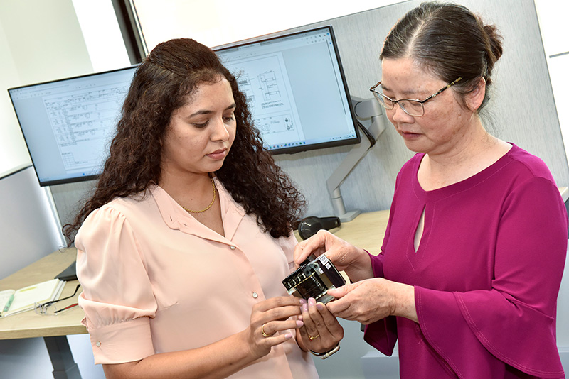 engineers examine control transformer